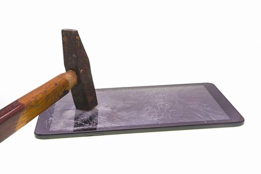 Broken screen tablet with a hammer over white