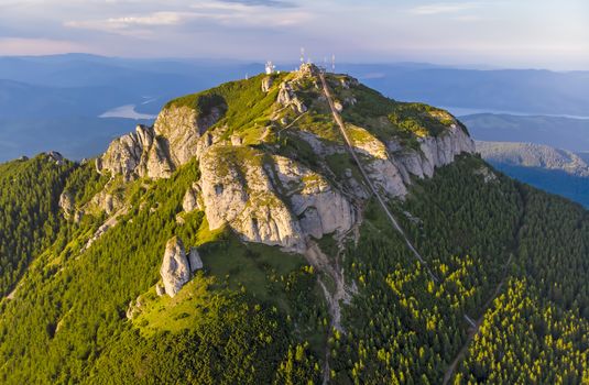 Aerial view of mountain peak: stairs for tourists in a summer landscape, Ceahlau mountain in Romanian Carpathians