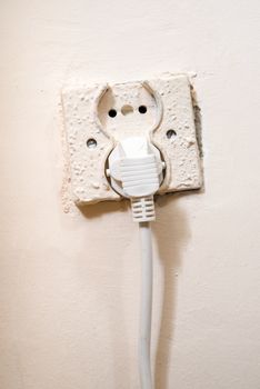 Old power socket with electric cable plug