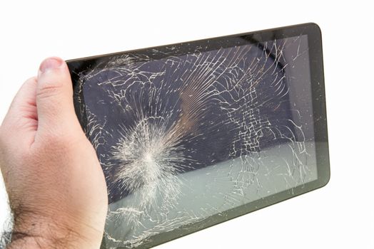 Hand holding a broken tablet over white