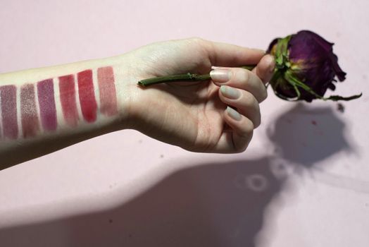 Lipstick color palette on a woman's hand