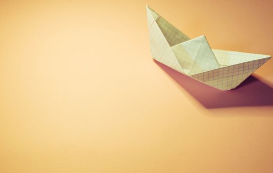 Paper boat on colored backgrounds