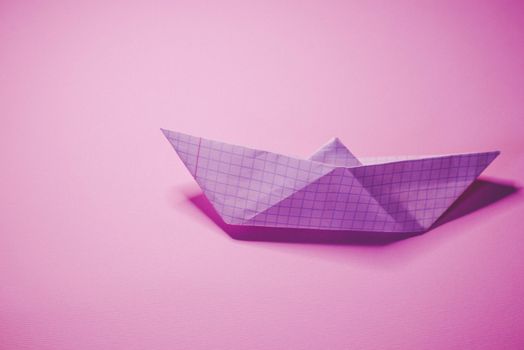 Paper boat on colored backgrounds