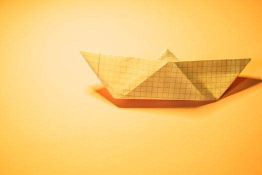 Paper boat on colored backgrounds