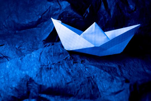 Paper boat on colored backgrounds