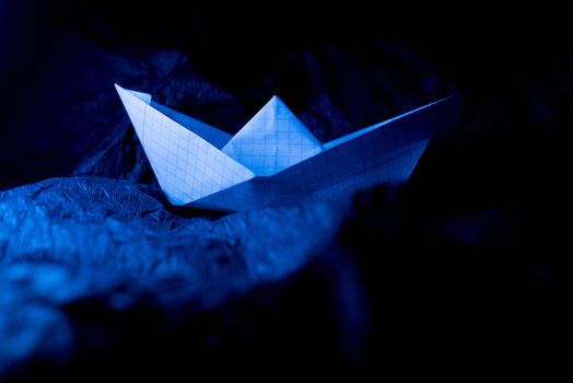 Paper boat on colored backgrounds