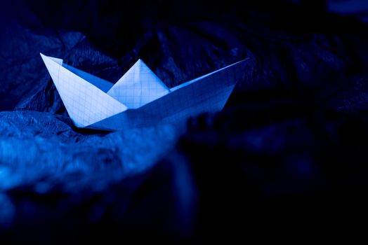 Paper boat on colored backgrounds