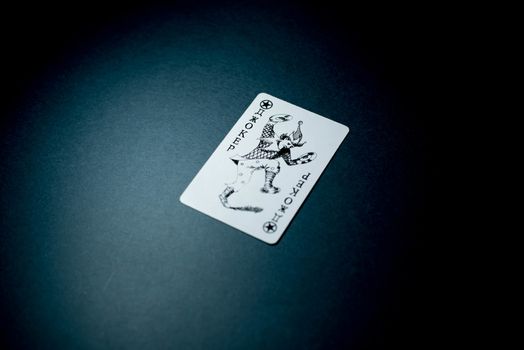 Joker card on a black background