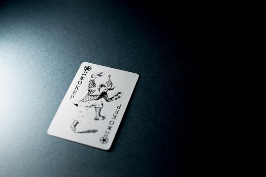 Joker card on a black background