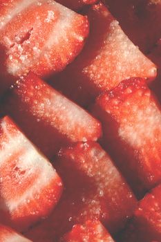 Strawberry slices in sugar filling background. Strawberry with sugar texture. Vitamin berry backdrop.