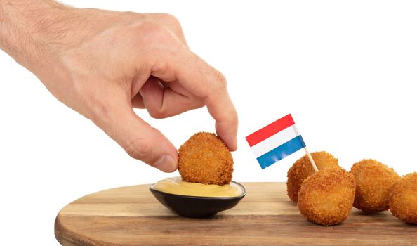 Dutch traditional snack bitterbal in a hand, isolated