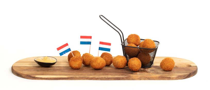 Dutch traditional snack bitterbal on a serving board, isolated
