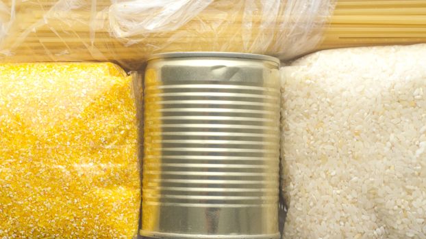 Food supplies, crisis food stock for quarantine isolation period. Pasta, corn grits and canned food. Food background.Food delivery, coronavirus quarantine. 