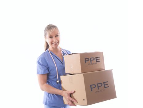 Smiling female nurse or healthcare worker holding a delivery of much needed boxes of PPE or other critical medical equipment.  During pandemic of COVID-19 supplies of critical personal protective equipment were in short supply.