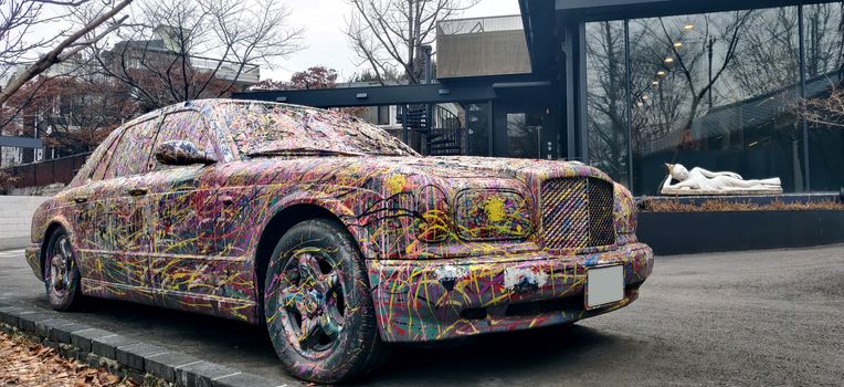 A painted modern car and a lying Buddha statue in Seoul, South Korea