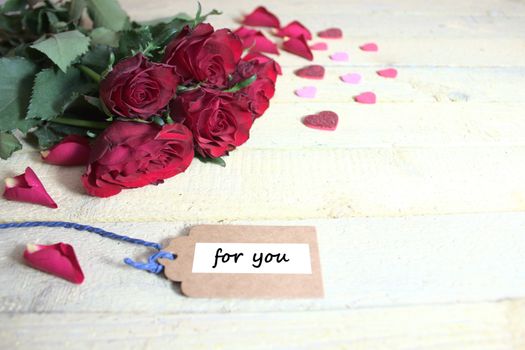 The picture shows red roses and hearts with the text for you