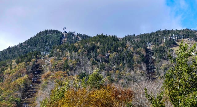 Mountains with Sky Lifts in Off Season on Sunny Autumn Day