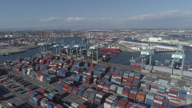 Aerial view panoramic oil tanker moving pass sea port warehouse and container ship or crane ship working for delivery containers shipment.