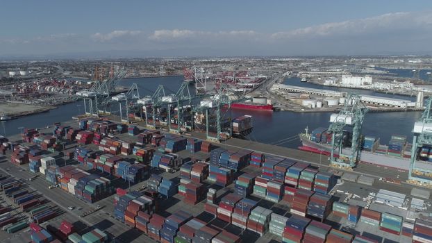 Aerial view panoramic oil tanker moving pass sea port warehouse and container ship or crane ship working for delivery containers shipment.