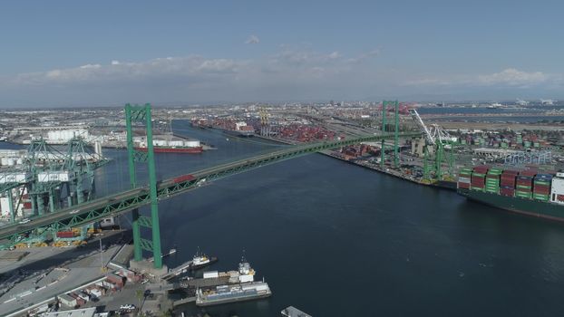 Aerial view panoramic oil tanker moving pass sea port warehouse and container ship or crane ship working for delivery containers shipment.