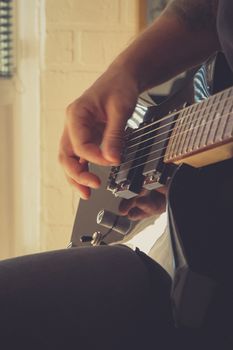 Playing the guitar. Guitarist's hand dynamic motion. Musical lifestyle background. Macro closeup.