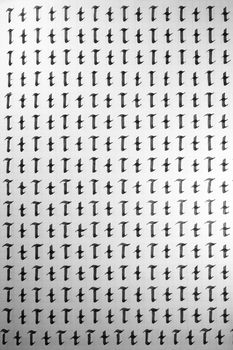 Handwriting black and white symbol filling pattern. Calligraphic letter T learning skills paper page. Calligraphy letters t background. Lettering practice writing worksheet.