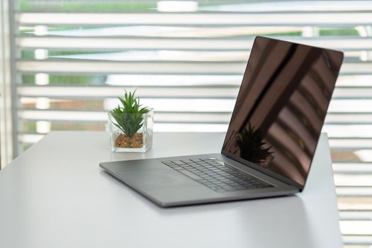 The laptop is placed on the work desk. Working in the office. Business concepts, investors, accounting, clerks. A relaxed and convenient workplace.