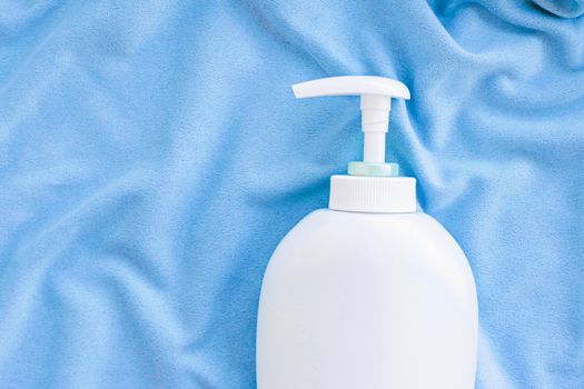 Blank label bottle of antibacterial liquid soap and hand sanitizer mockup on blue silk, hygiene product and health care, flatlay