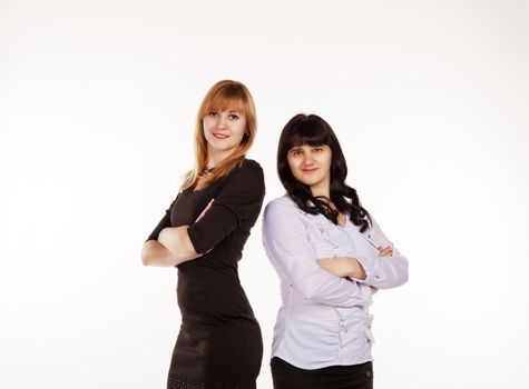 two young beautiful business women standing smiling