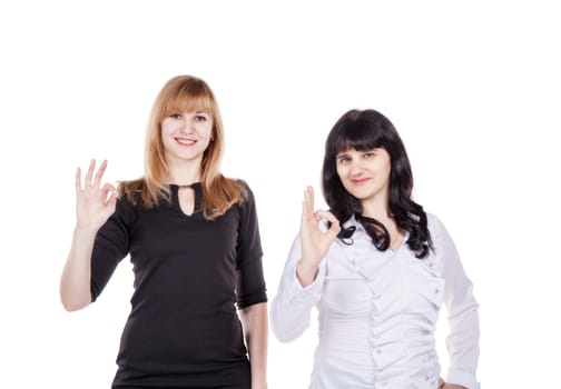 two young beautiful women showing sign o'kay