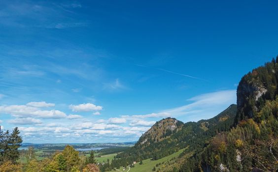 Beautiful nature of European Alps, landscape view of alpine mountains, lake and village on a sunny day, travel and destination scenery