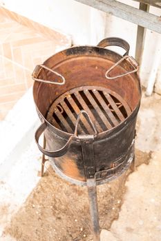 retro charcoal stove used for cooking in the countryside or for making a fire while camping in the forest.