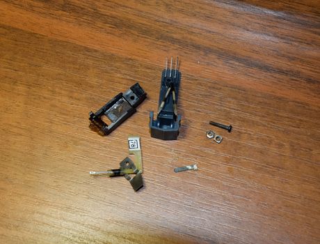 Disassembled vinyl player pickup with a rotary needle.