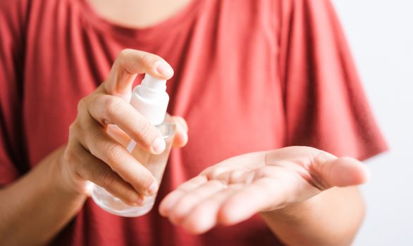 Closeup Hand Asian young woman applying spray pump dispenser sanitizer alcohol on hand wash cleaning, hygiene prevention COVID-19 or coronavirus protection concept, isolated on white background