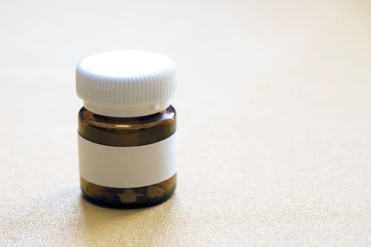 tablet bottle of medicine, photo isolated on a yellow background. Mock-up.