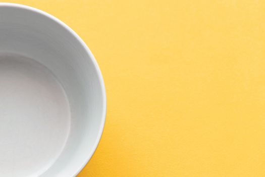Empty white Cup on a yellow background, isolate.