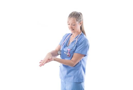 Nurse or doctor washing hands using an alcohol rub.  Hand hygiene before and after a procedure is essential practice