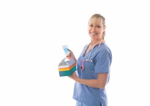 Friendly nurse in scrubs holding a box of surgical medical masks. Much needed PPE during flu season or pandemic such as coronavirus, SARS, MERS or other surgical procedures