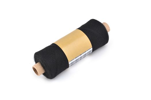 Color bobbin of yarn with label. Side view. Textile reel on isolated white background. Use for store