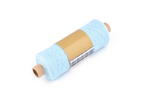 Color bobbin of yarn with label. Side view. Textile reel on isolated white background. Use for store