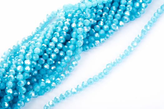 Beautiful Light Blue Glass Sparkle Crystal Isoalted Beads on white background. Use for diy beaded jewelry