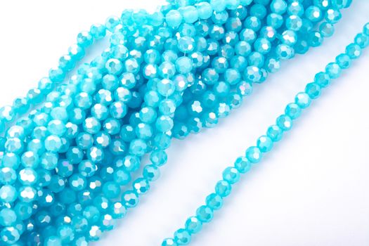 Beautiful Light Blue Glass Sparkle Crystal Isoalted Beads on white background. Use for diy beaded jewelry