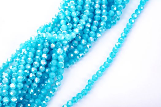 Beautiful Light Blue Glass Sparkle Crystal Isoalted Beads on white background. Use for diy beaded jewelry