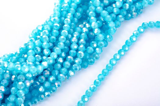 Beautiful Light Blue Glass Sparkle Crystal Isoalted Beads on white background. Use for diy beaded jewelry