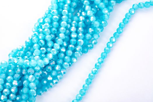 Beautiful Light Blue Glass Sparkle Crystal Isoalted Beads on white background. Use for diy beaded jewelry