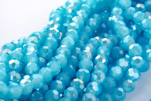 Beautiful Light Blue Glass Sparkle Crystal Isoalted Beads on white background. Use for diy beaded jewelry