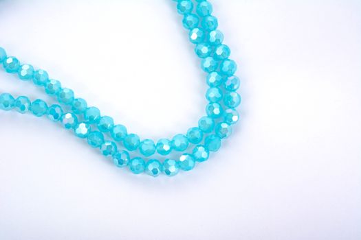 Beautiful Light Blue Glass Sparkle Crystal Isoalted Beads on white background. Use for diy beaded jewelry
