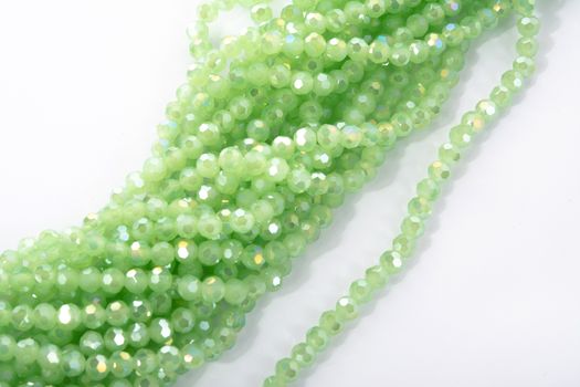 Beautiful Light green Glass Sparkle Crystal Isoalted Beads on white background. Use for diy beaded jewelry