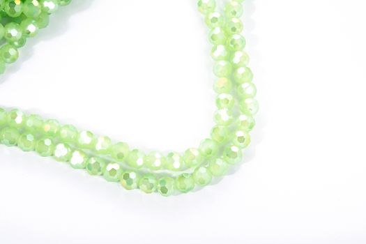 Beautiful Light green Glass Sparkle Crystal Isoalted Beads on white background. Use for diy beaded jewelry
