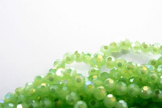 Beautiful Light green Glass Sparkle Crystal Isoalted Beads on white background. Use for diy beaded jewelry